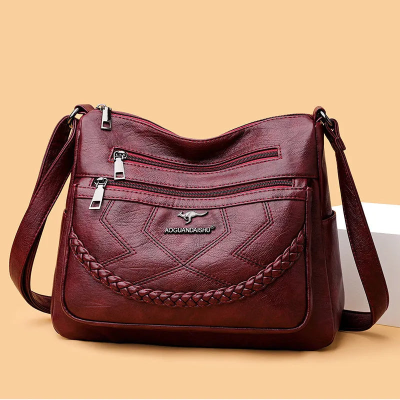 Women's black PU leather crossbody shoulder bag with large capacity and zipper compartment