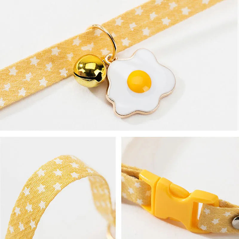 Green adjustable pet collar with a metal bell pendant and a matching bow tie on a white background.
