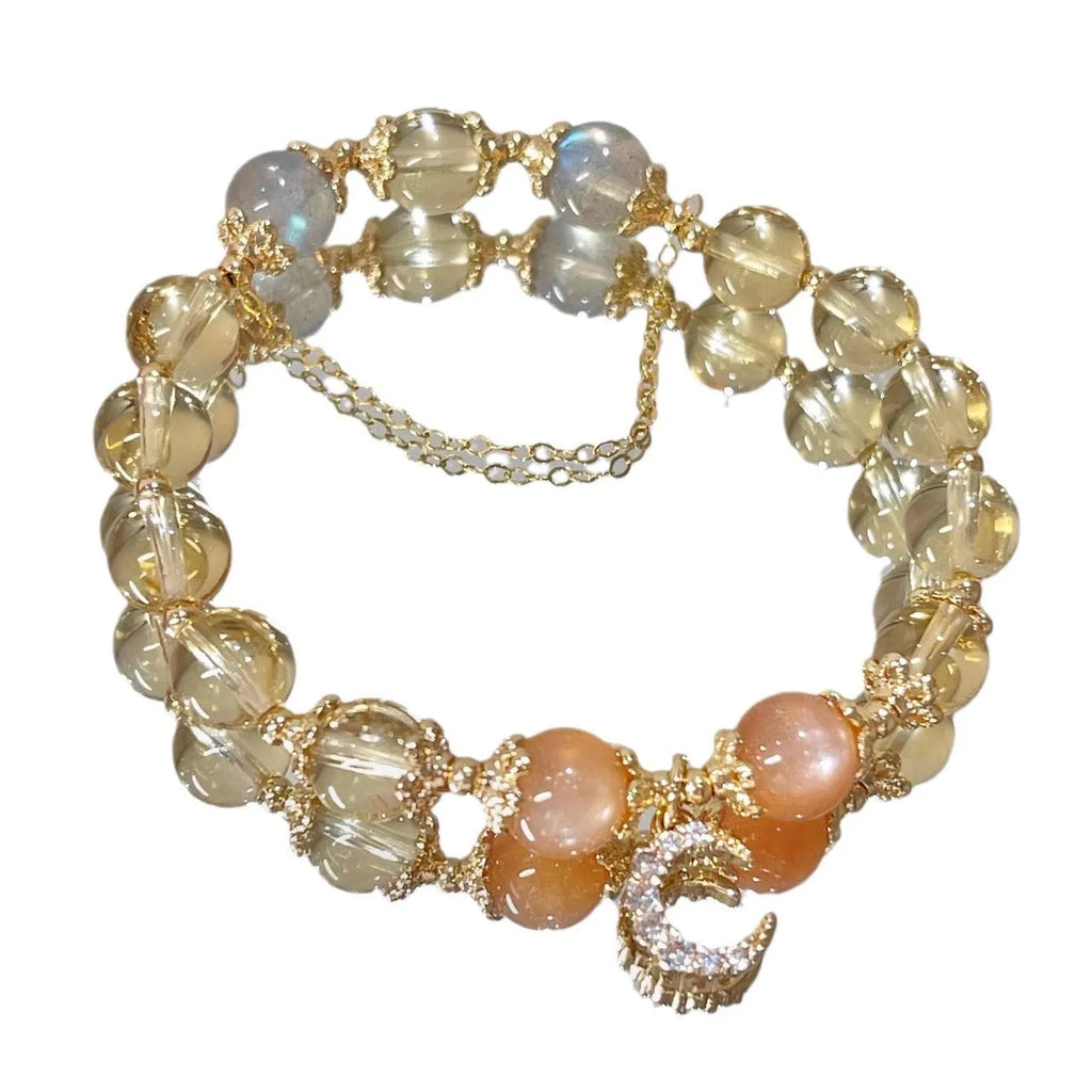 Women's crystal bracelet with moonstone and golden sun stone centrepiece, 14K gilded electroplated links, Chinese diamond-shaped style.
