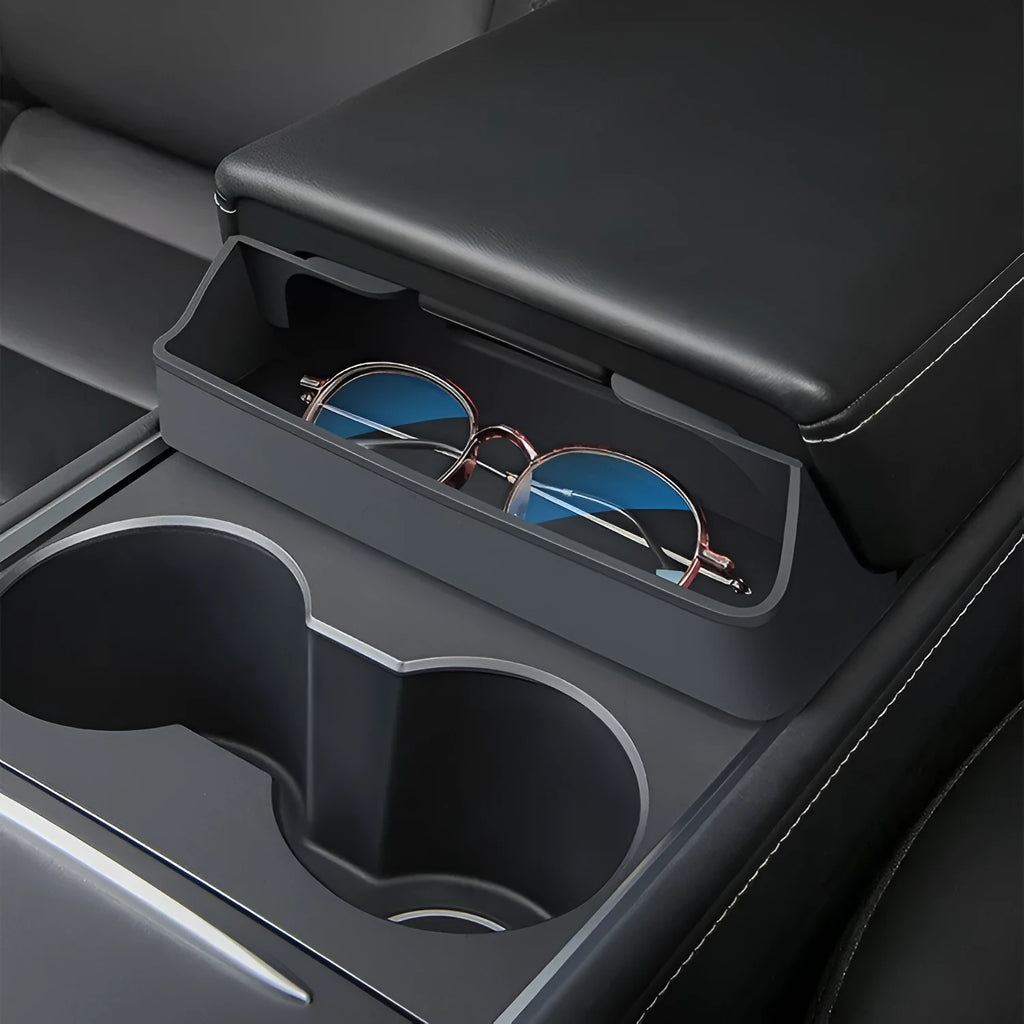 Black silicone glasses case mounted on a Tesla Model 3 or Y central armrest.