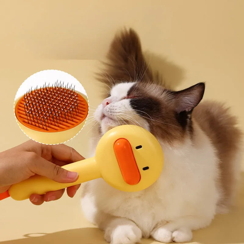 Small yellow duck-shaped comb for pet grooming with needle points and floating hair removal device