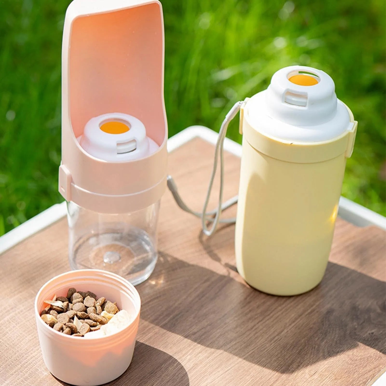 Grey 2-in-1 travel dog water bottle and feeder with lanyard, showing water and food compartments