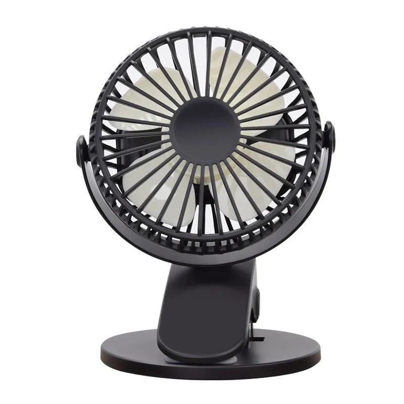 White USB rechargeable mini clip fan attached to a desk edge showing piano button switch and plastic blades.