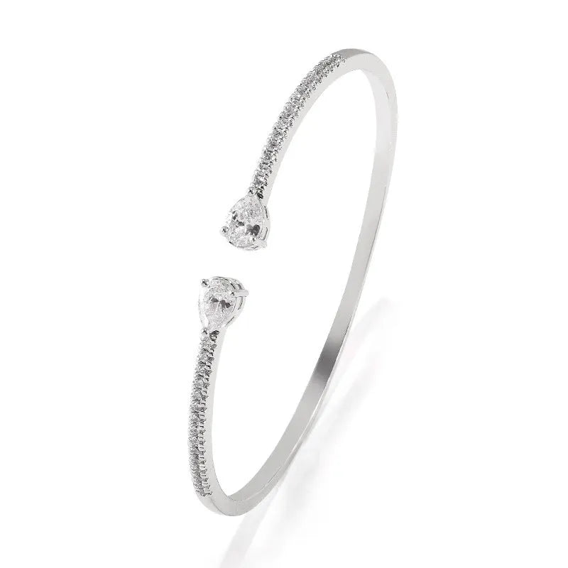 Copper bracelet with multi-zircon inlay in simple style, shown in white and blue colour options.