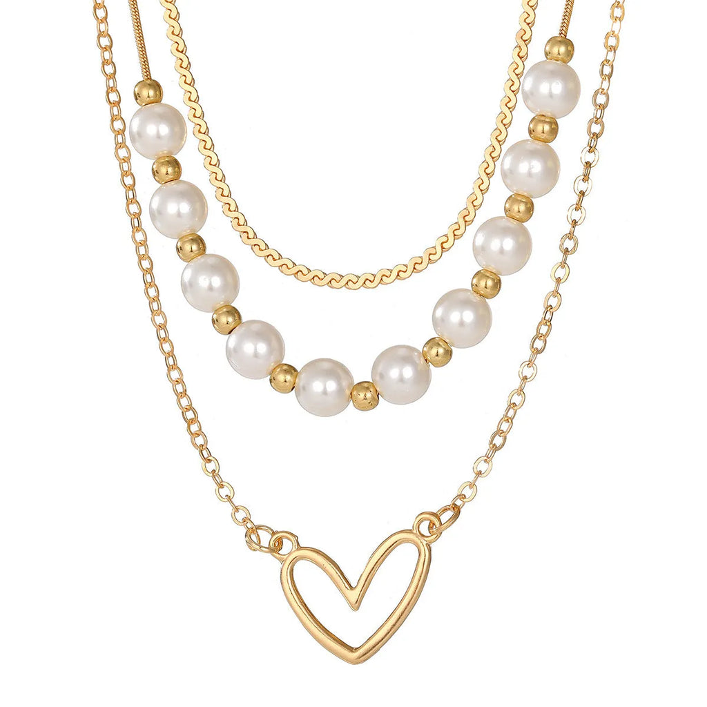 Vintage gold heart pendant necklace with pearl chain detailing showing adjustable length feature