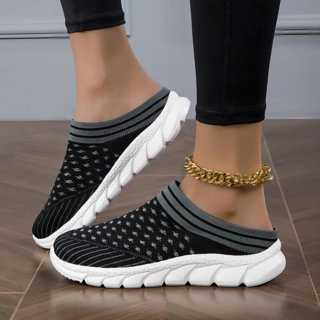 Women's black flyknit semi-slipper sock shoes with striped pattern and hollowed-out sewing lines on a lightweight sole.