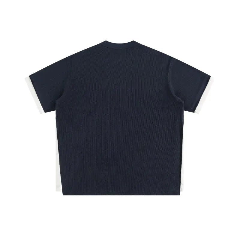 Retro alphabet embroidered loose waffle short-sleeved t-shirt in navy blue, laid flat.