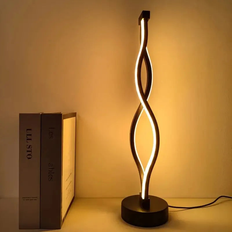 Black aluminium desk lamp with a touch dimming button showing three colour LED lights.