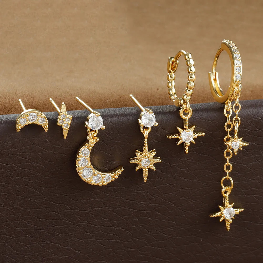 XINGX set of six gold electroplated chain tassel earrings with zircon studs on display