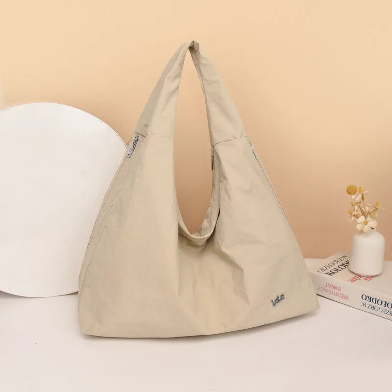 Women's soft nylon underarm bag in a heart shape, shown in black, blue, khaki, and yellow colour options.