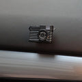 Pack of four retro camera dot design adhesive hooks for car interiors.