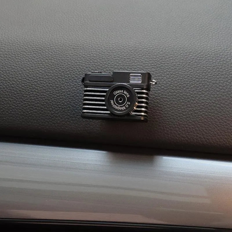 Pack of four retro camera dot design adhesive hooks for car interiors.