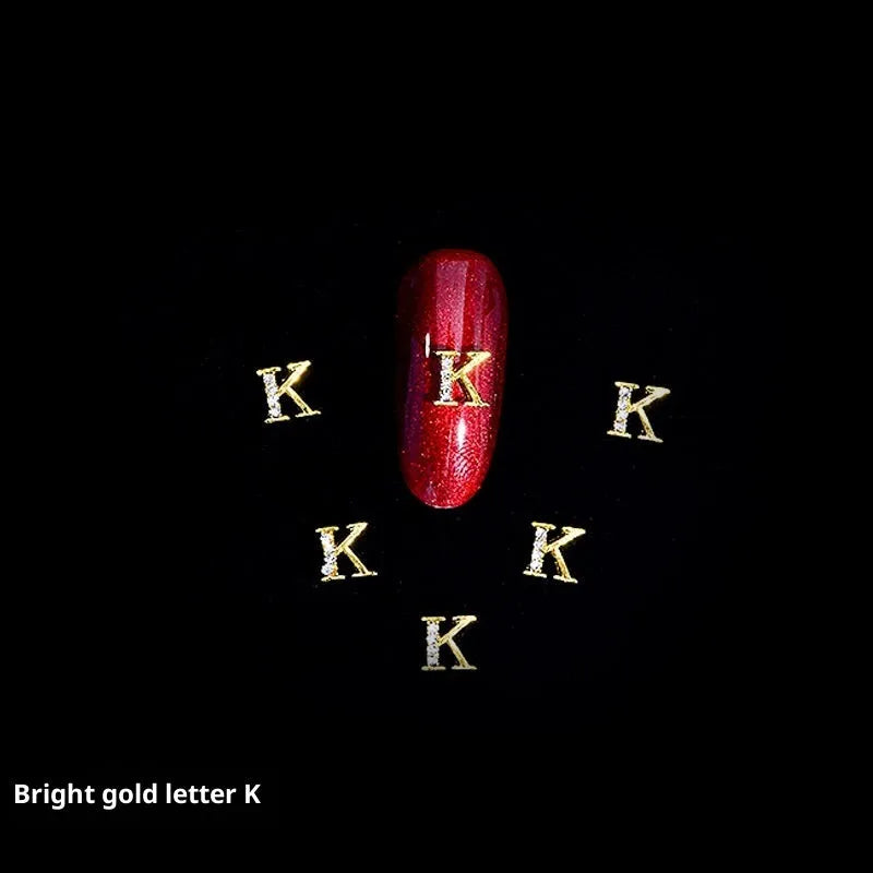 Gold alloy letter A nail ornament charm with crystal detail on a square chain base