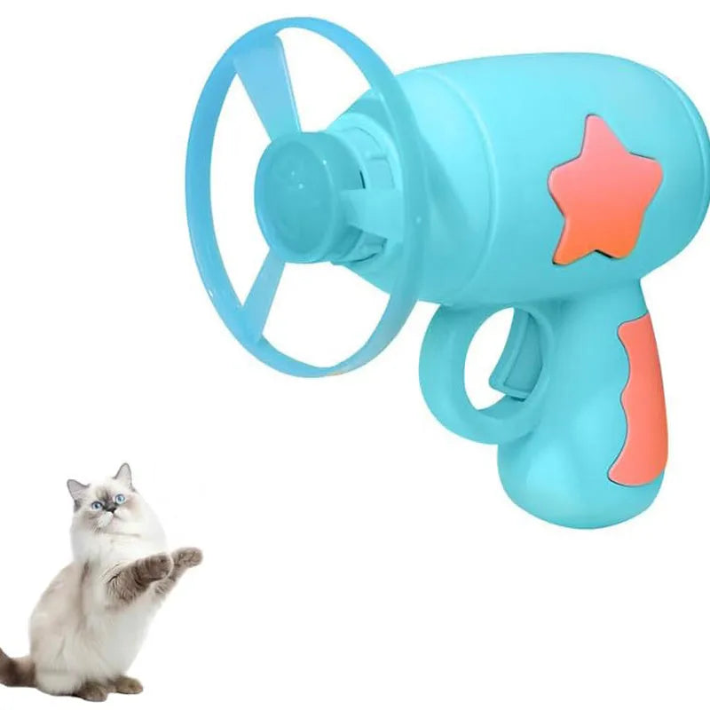 Blue plastic cat toy gun launcher with a mounted orange Frisbee, shown next to a second green Frisbee.
