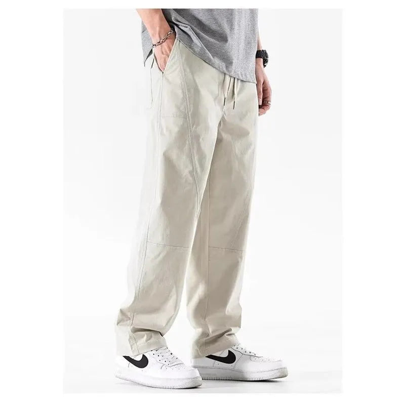 Cotton wide-leg casual trousers in Milky White hanging on a hanger, showing relaxed fit and full length.