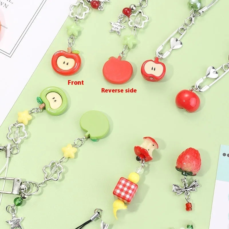 Plastic resin fruit phone charm keychain with strawberry design on white rope cord