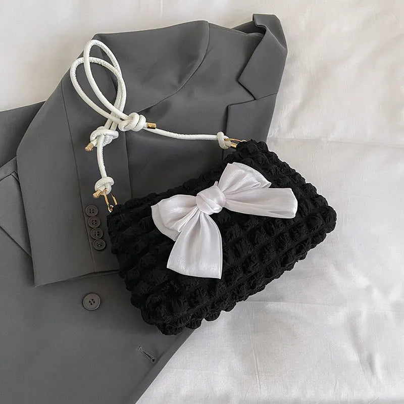 Women's canvas shoulder handbag with sandwich pocket design in black colour showing horizontal square shape