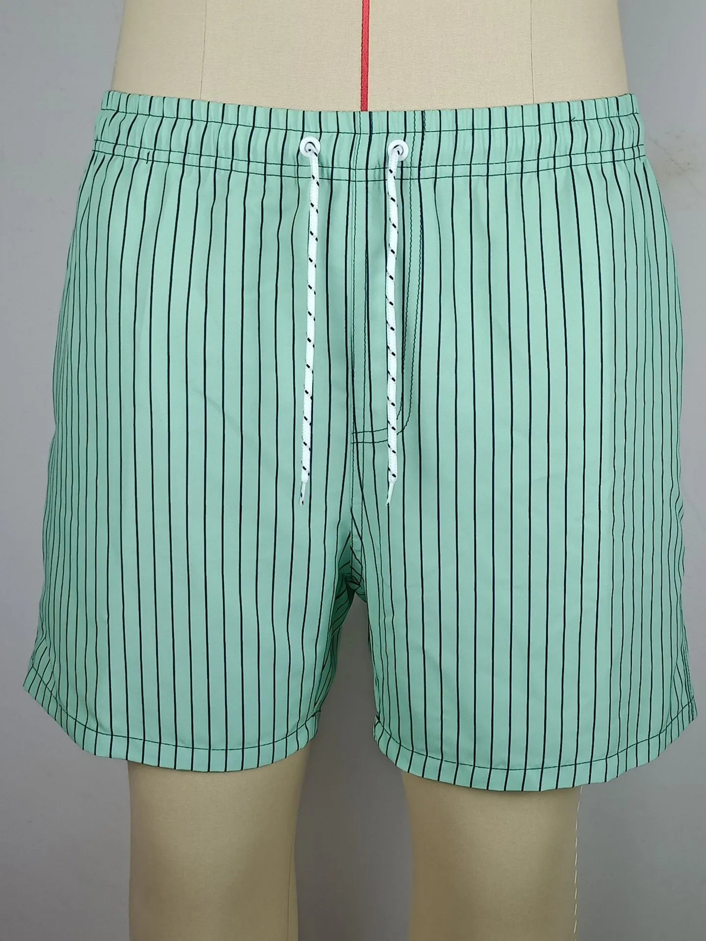 Men's striped beach shorts in navy blue, made from polyester fibre with a straight leg opening.