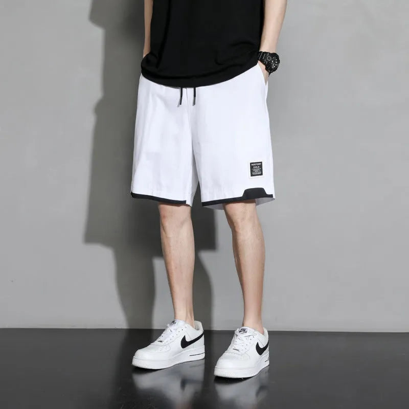 Boys cotton shorts in black, shown in a casual setting for summer.