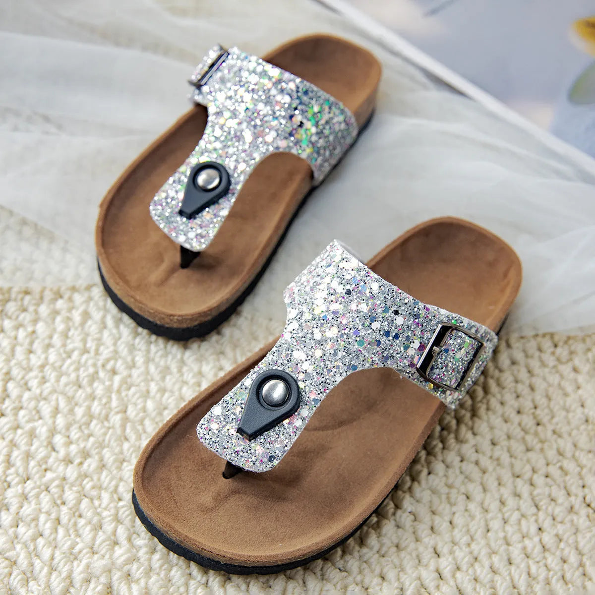 Women's cork flip-flops with frosted metallic artificial leather upper and textured PVC sole.