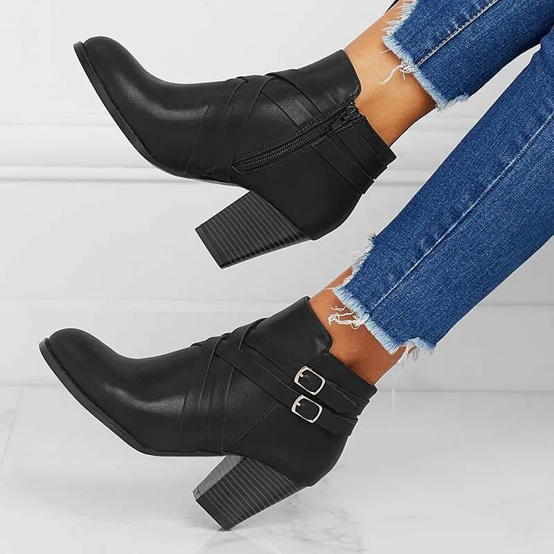 Men's black short ankle boots with side zip, belt buckle, and a 7cm heel.