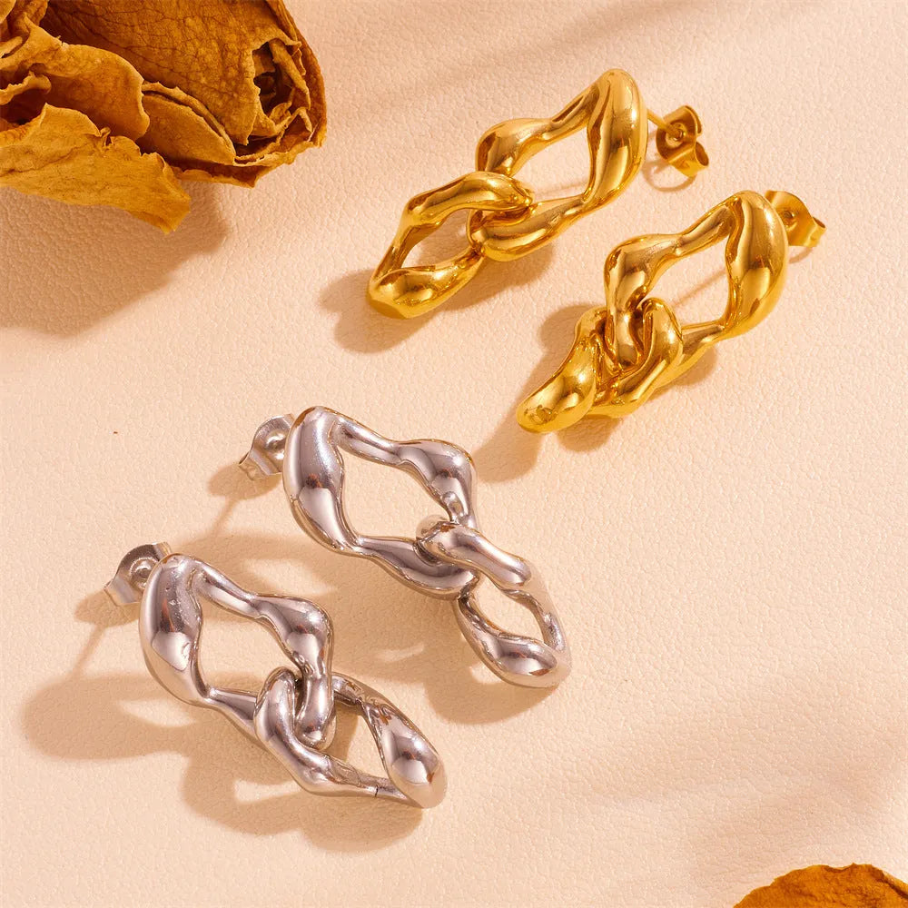 Heart shape titanium steel earrings in gold leaf style on white background