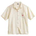 Light apricot men's short sleeve shirt with a bamboo floral pattern and a Cuban collar.
