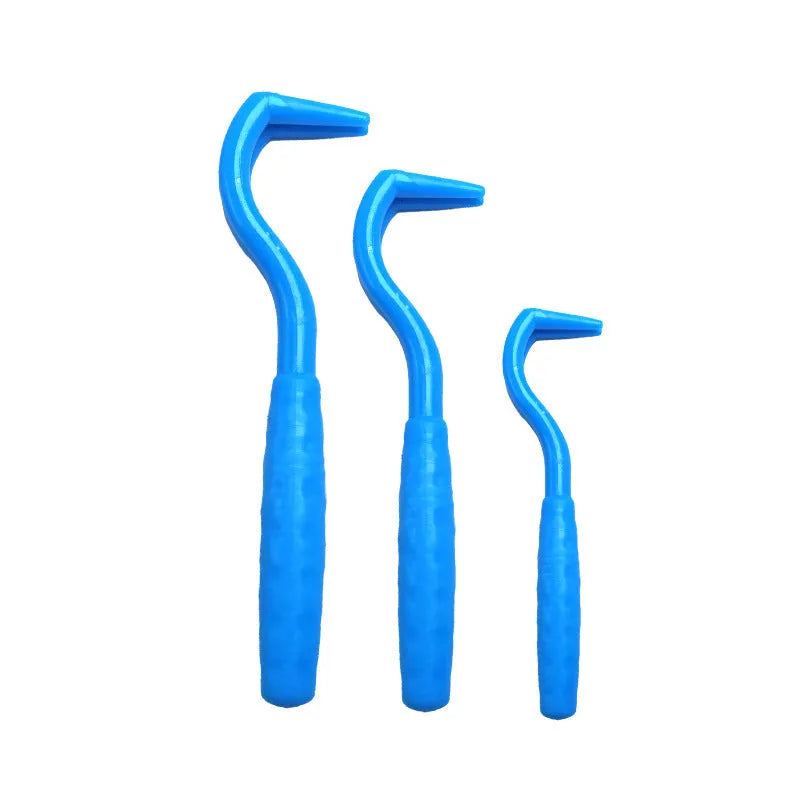 Three plastic tick removal hooks for dogs in assorted colours on a white background.