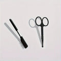 Black ambidextrous pet grooming brush with soft bristles and a comb for dogs and cats.