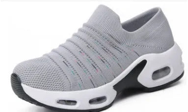 Women's fly-knit stretch sock shoes in light grey with low heel and round toe.