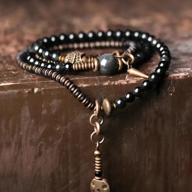 Black multi-layered beaded bracelet with geometric shapes showing natural style design