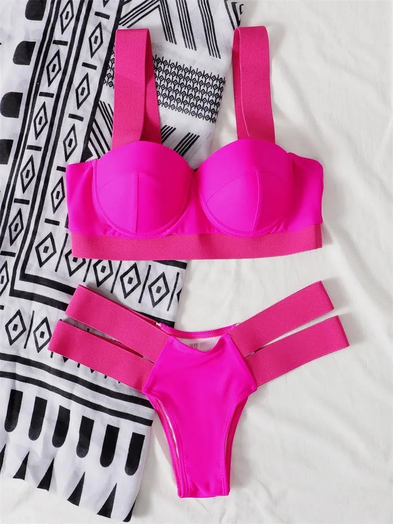 Women's rose red bikini swimsuit with black contrast trim and internal steel bracket push-up support