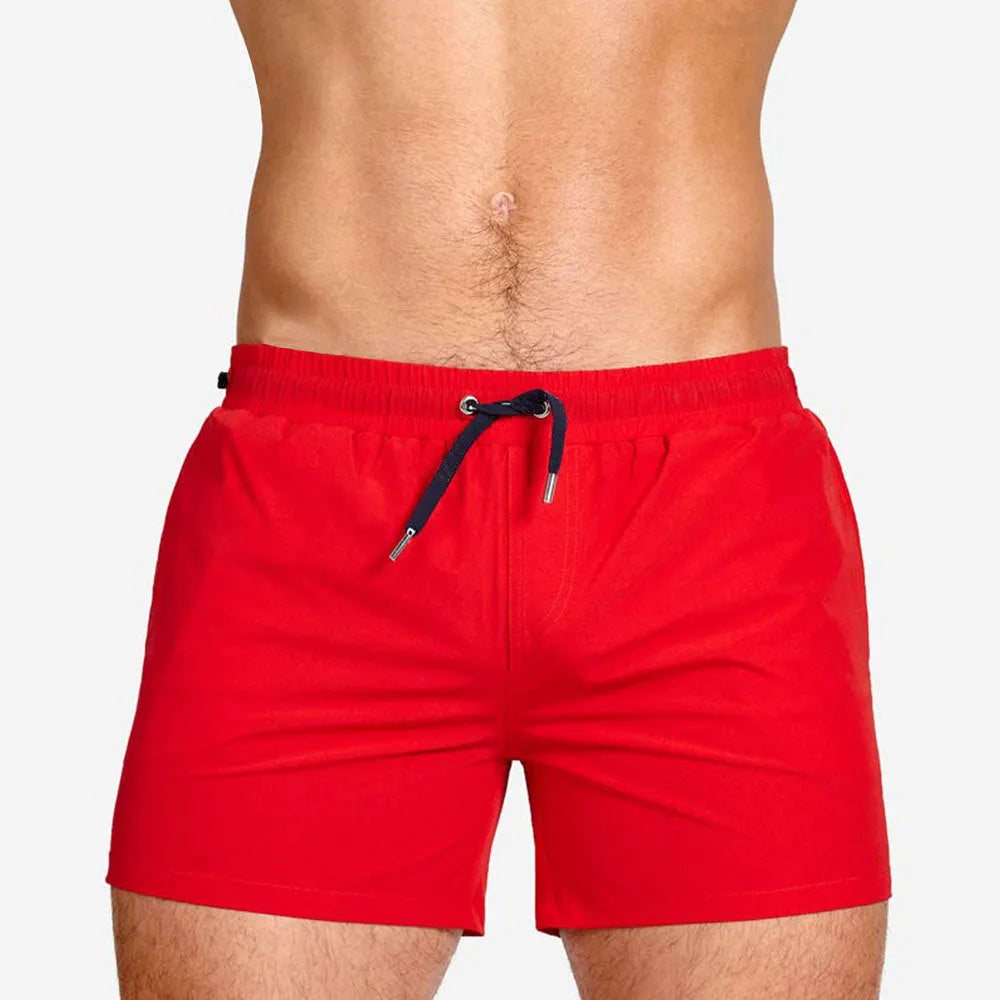 Men's solid colour mesh lining polyester sports shorts for swimming and fitness.