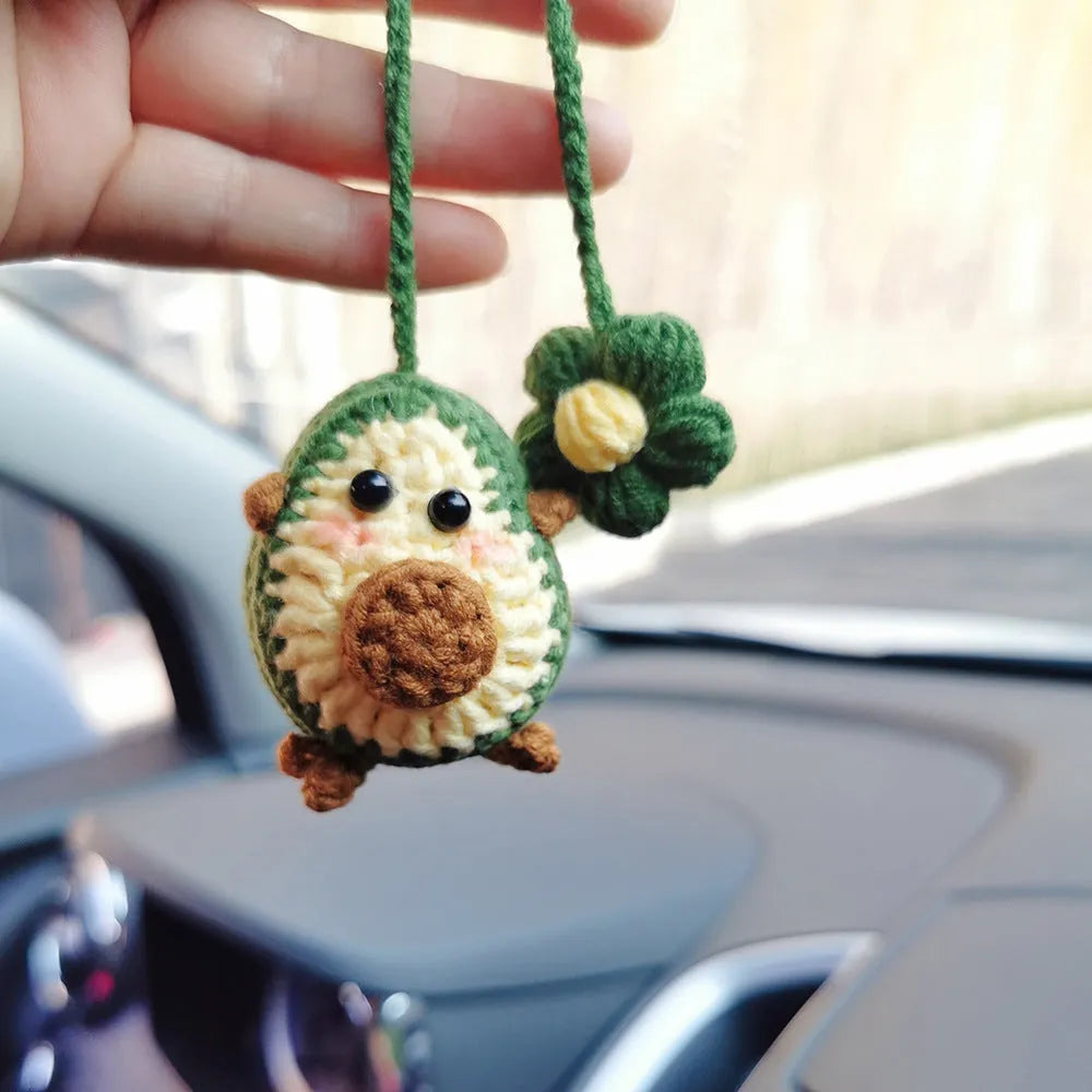 Handmade crocheted rainbow flower car pendant in wool with colourful avocado, pink, and red patterns