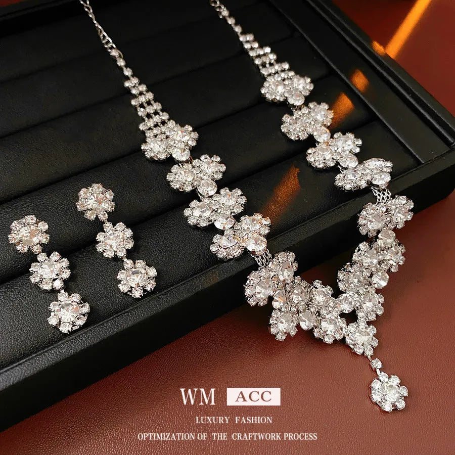 Diamond sunflower earrings and necklace set in silver finish on display