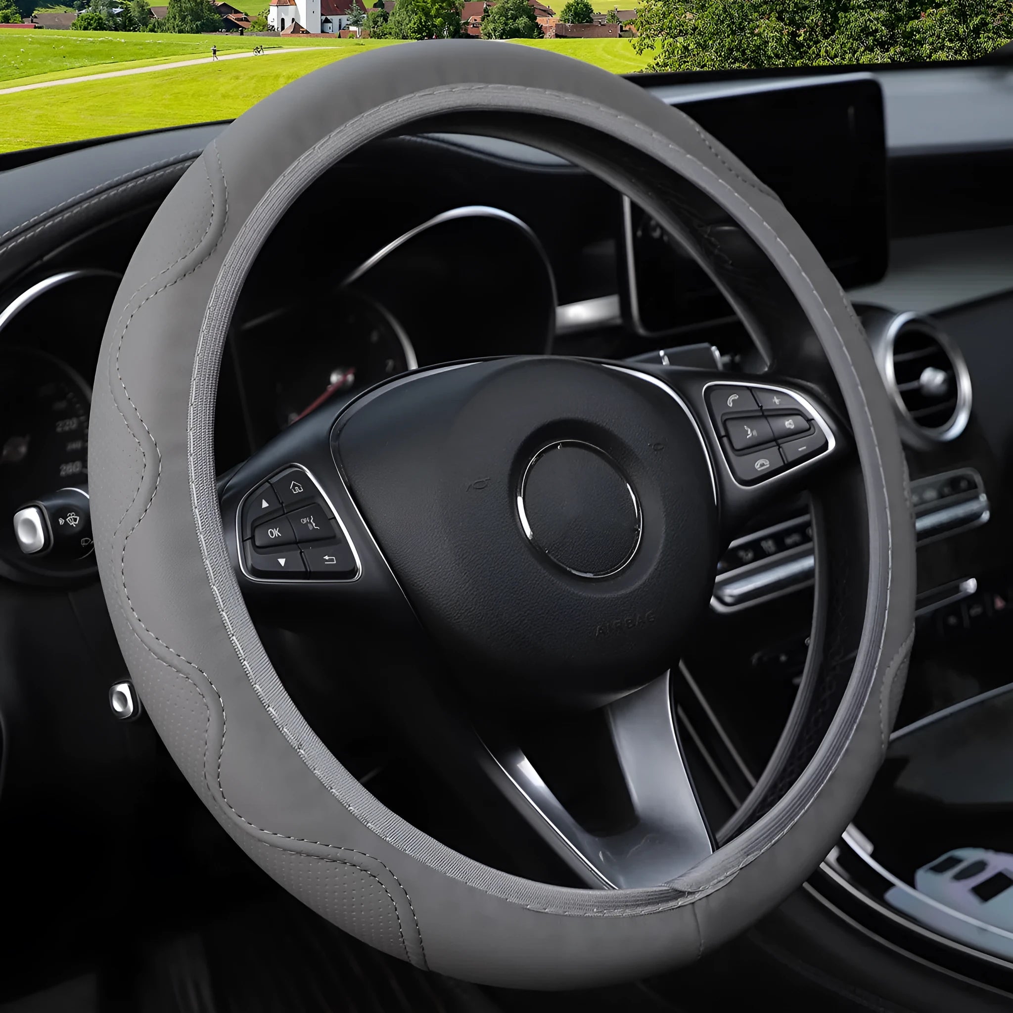 Black elastic steering wheel cover with corrugated texture, stretched to show fit on a 37-38cm wheel.
