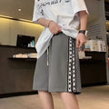 Men's loose black track pants with elastic waistband and baggy leg fit