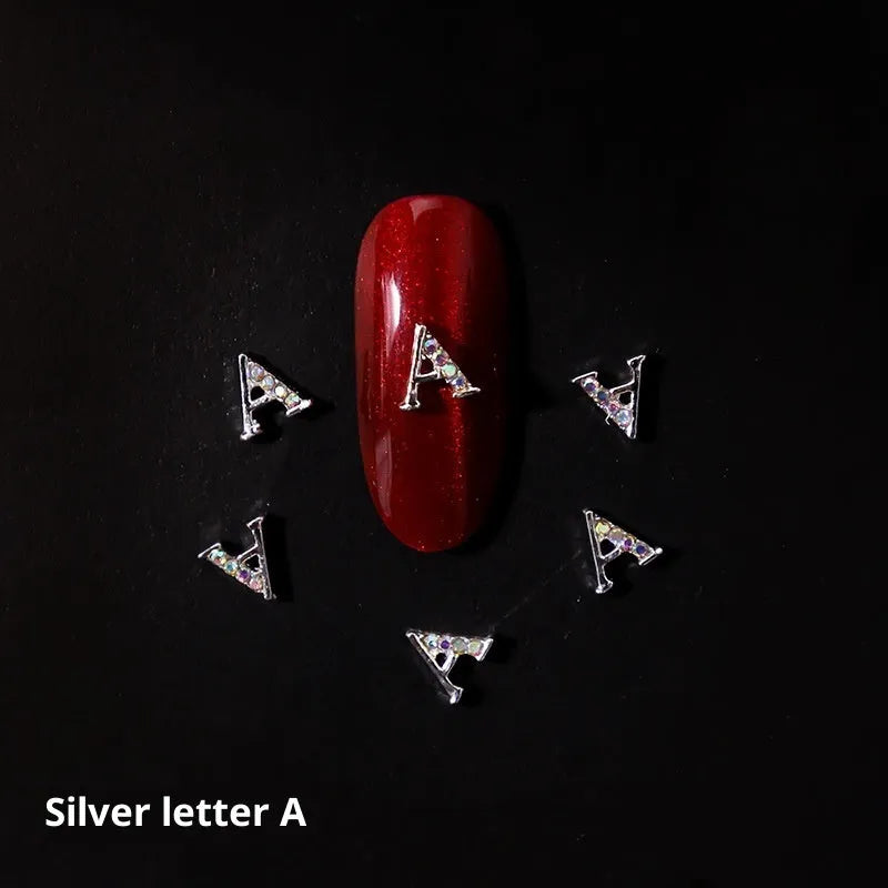 Gold alloy letter A nail ornament charm with crystal detail on a square chain base