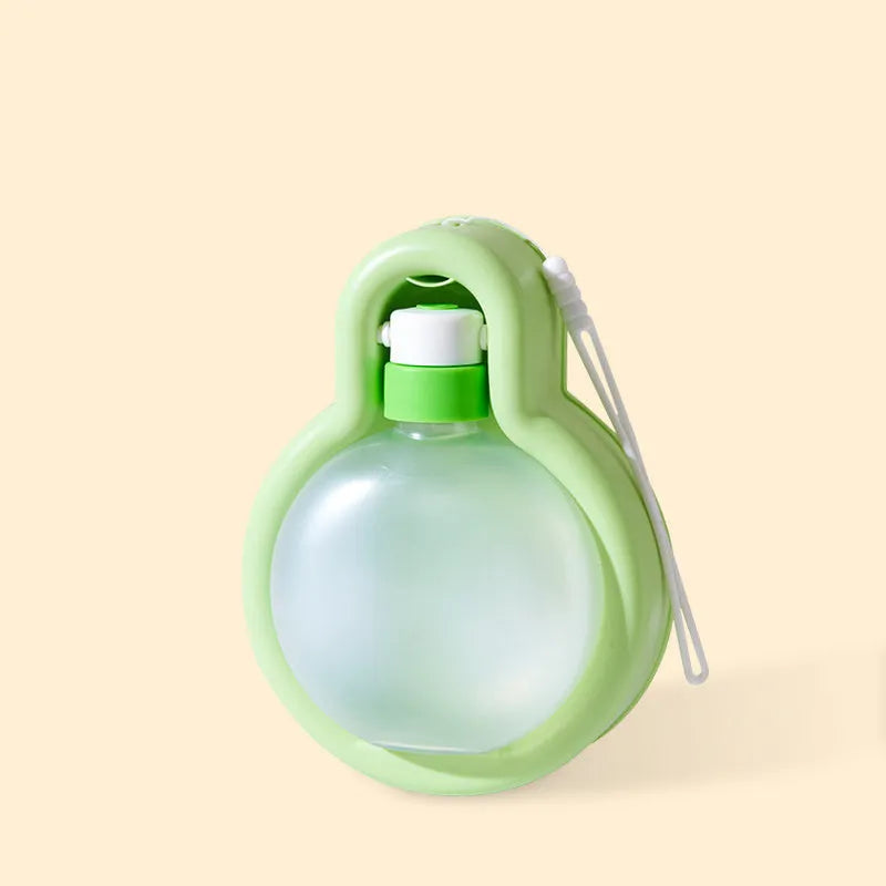 Green portable dog water bottle with pull-out drinking bowl for outdoor travel and camping.