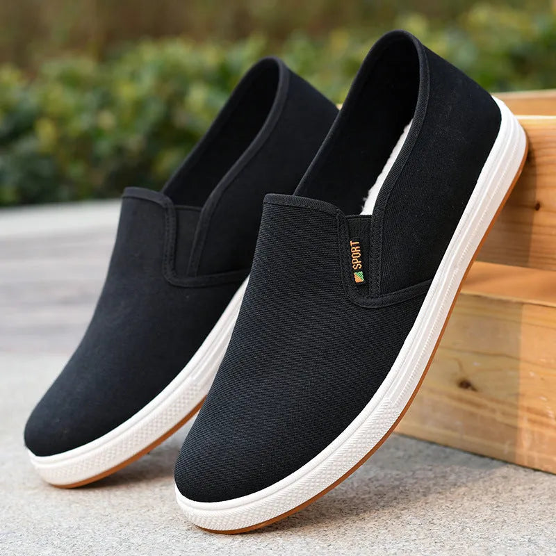 Men's black and blue canvas slip-on shoes with low-top design and round toe