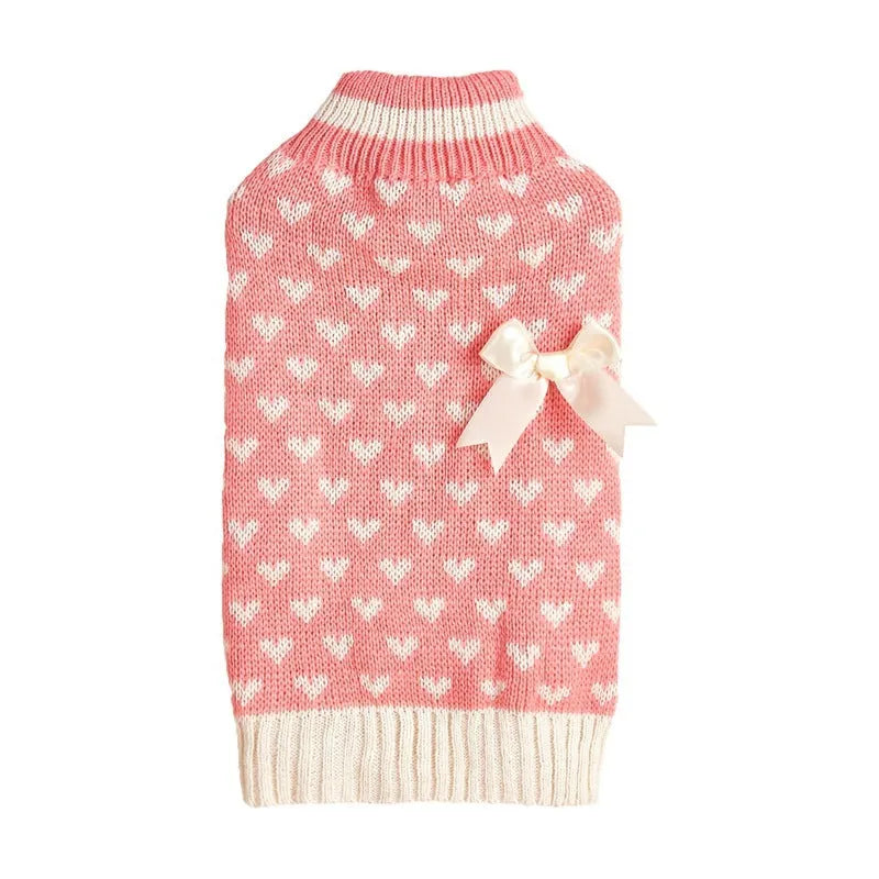 Dog wearing red love heart patterned sweater in acrylic knit fabric