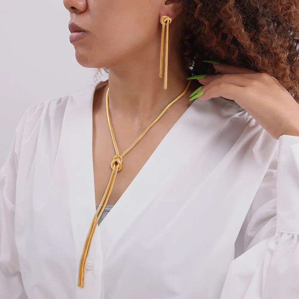 Gold knotted tassel pendant on snake chain necklace with matching earrings