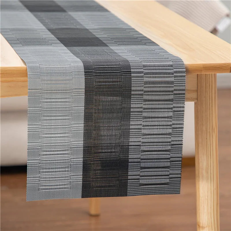 PVC non-slip dish mat in modern simple style on a dining table, showing gradient bamboo black colour option.
