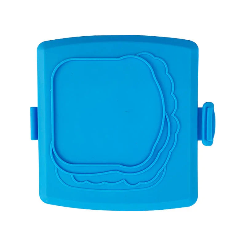 Red silicone baking tray and oven gloves set on a kitchen counter.