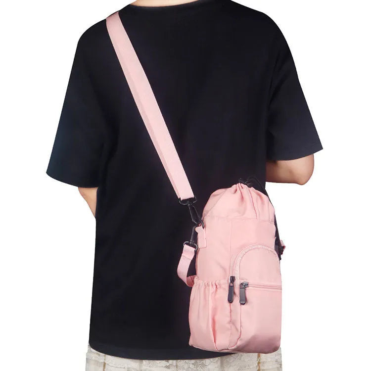 Black cloth crossbody water bottle pouch shown holding a bottle.