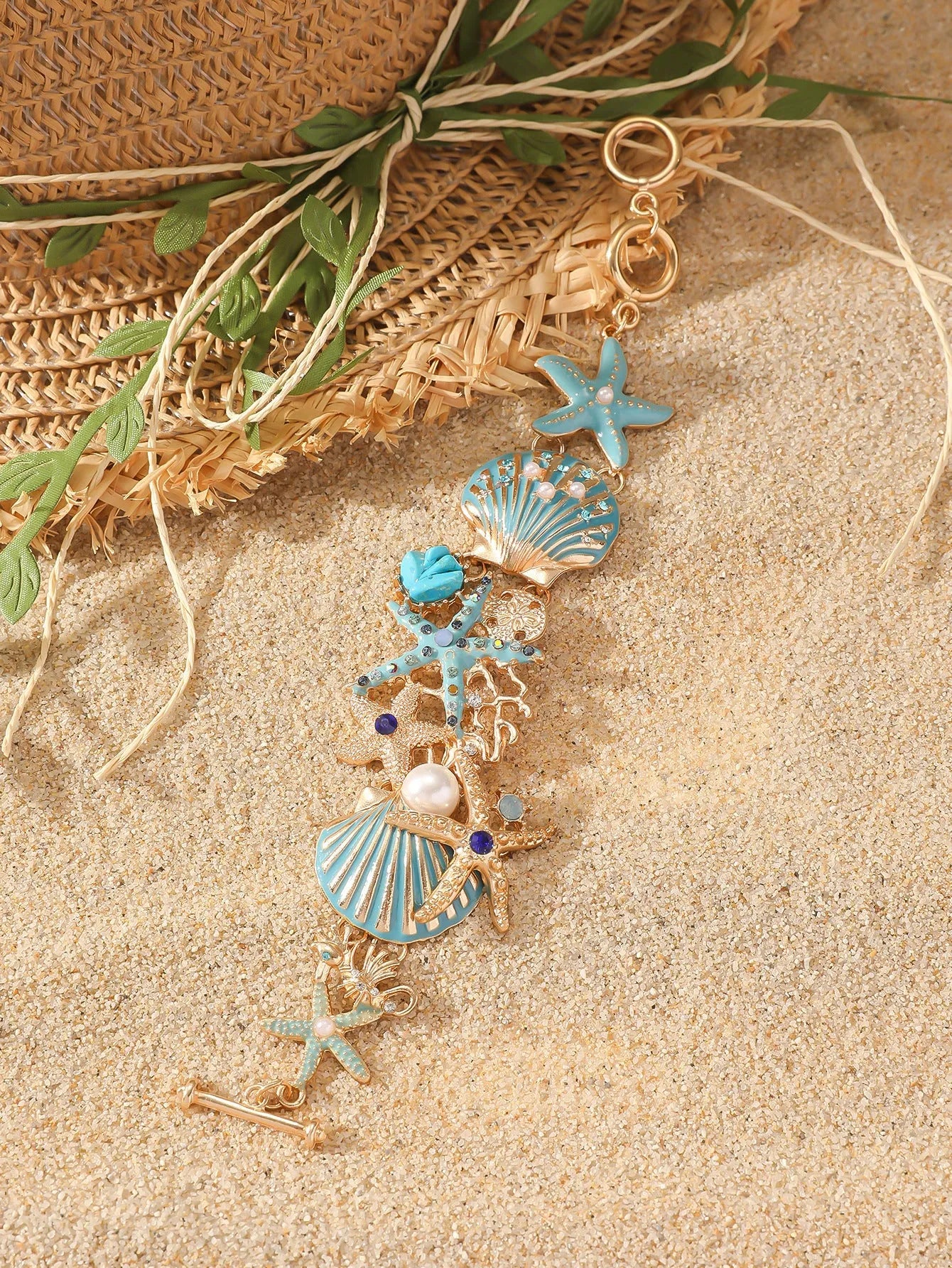 Women's alloy rhinestone bracelet with a nautical boat anchor and starfish design in blue coral colour.