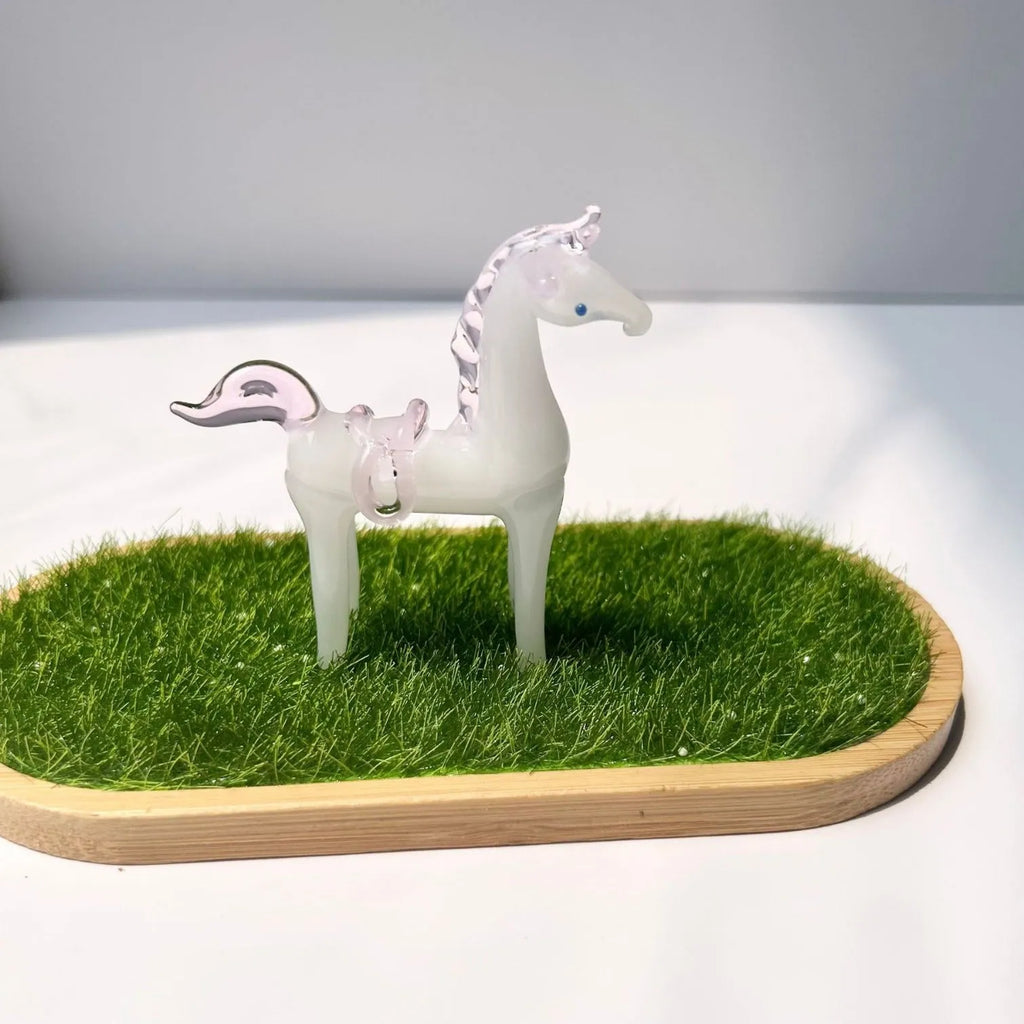 Brown glazed ceramic horse ornament on wooden shelf