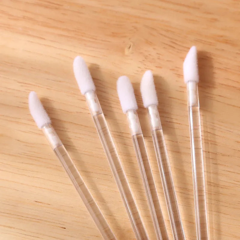 Disposable lip brushes with coloured handles and flocked brush heads for lip makeup application