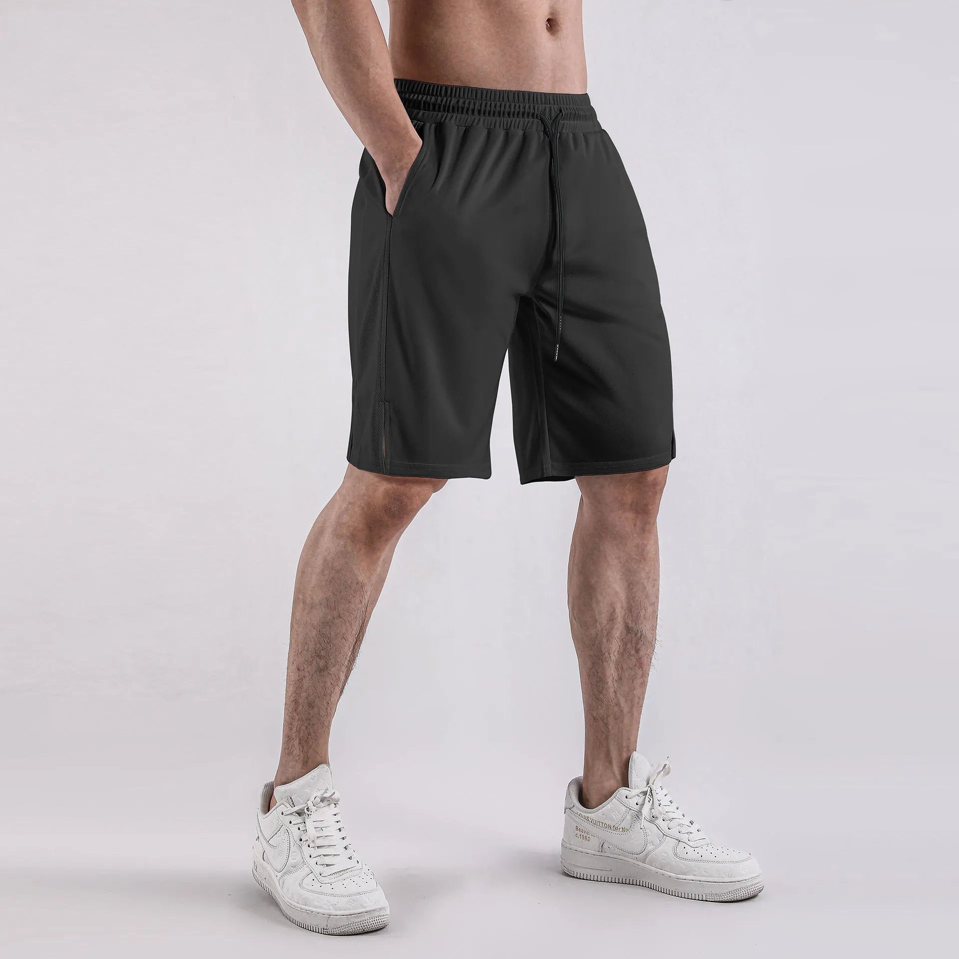 Men's black and white quick-dry mesh shorts with elastic waistband and loose fit