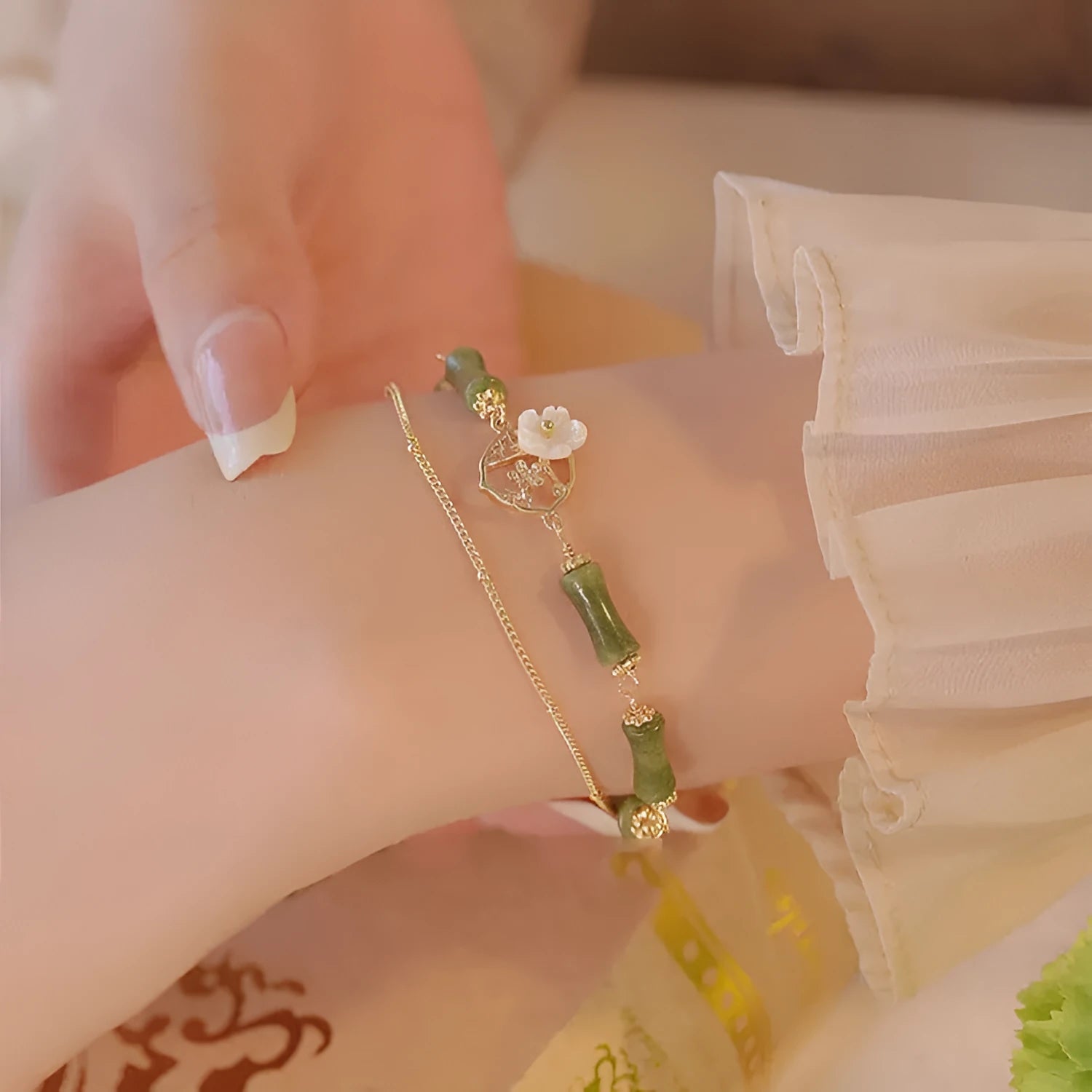 Natural olivine gemstone bracelet for women with double layer design and twin bells of Ireland charms.